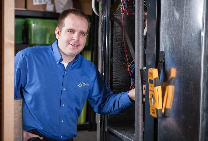 Technician repairing a furnace