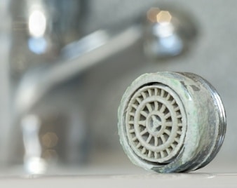 Underside of a faucet, showing build up from hard water