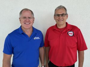 Kris Knochelmann and Jeff Niceley stand together to announce partnership of their businesses.